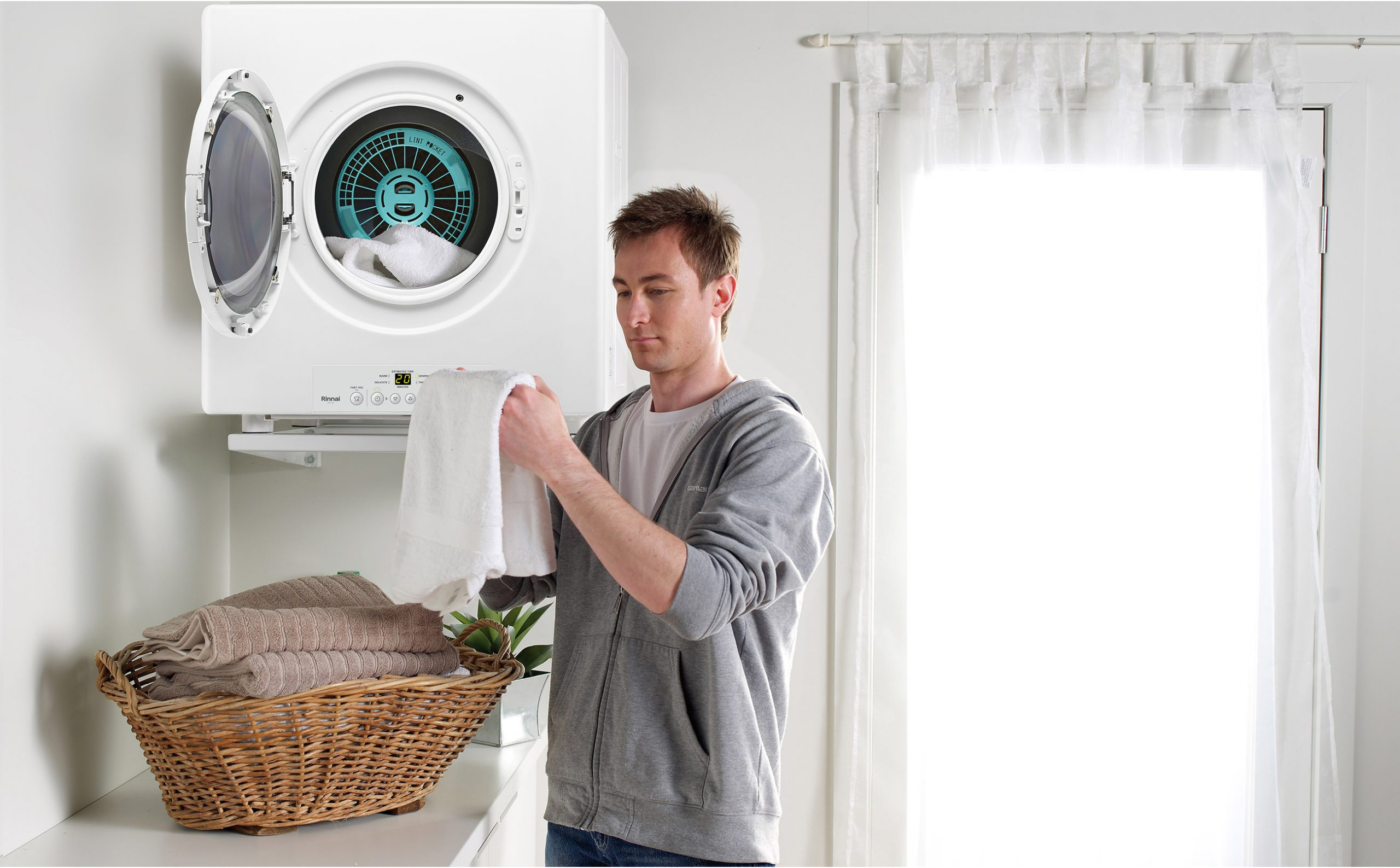 Rinnai Dry-Soft Gas Clothes Dryer (lifestyle - man front on door open)